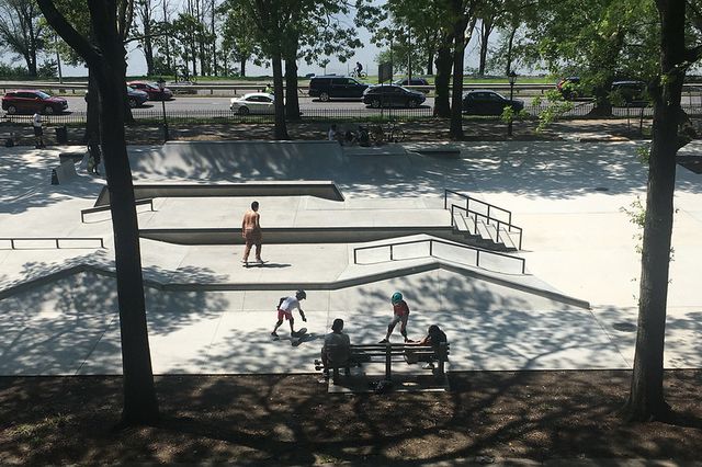 a few people skate in the Riverside Skate Park